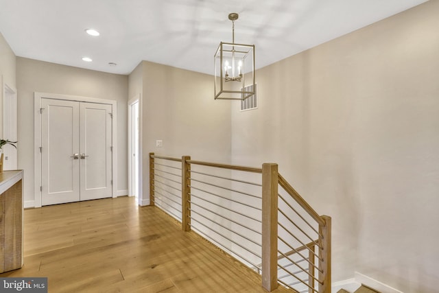 interior space featuring a notable chandelier and hardwood / wood-style flooring