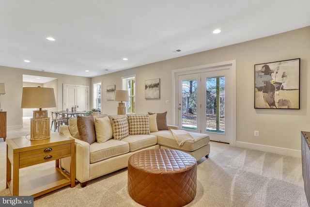 living room featuring light carpet and french doors