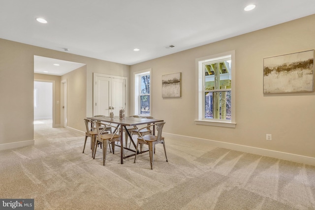 dining room featuring light colored carpet