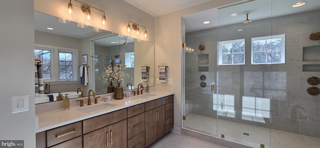 bathroom with a shower with door and vanity