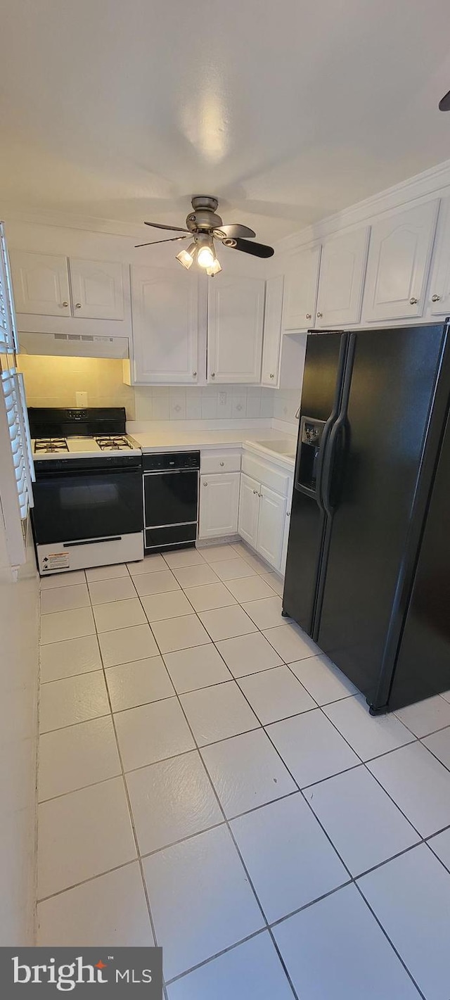 kitchen with ceiling fan, light tile patterned floors, white cabinetry, and black appliances