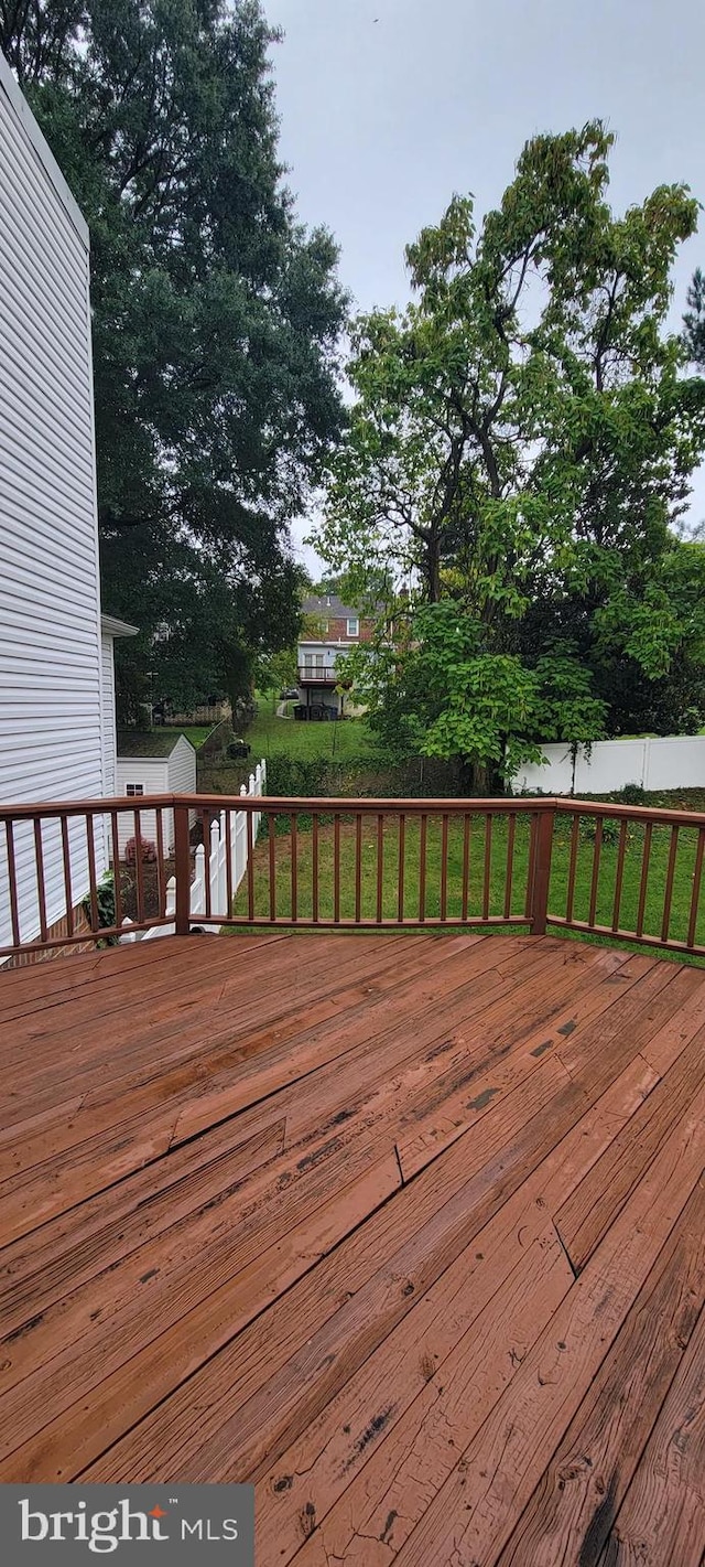 wooden terrace featuring a yard