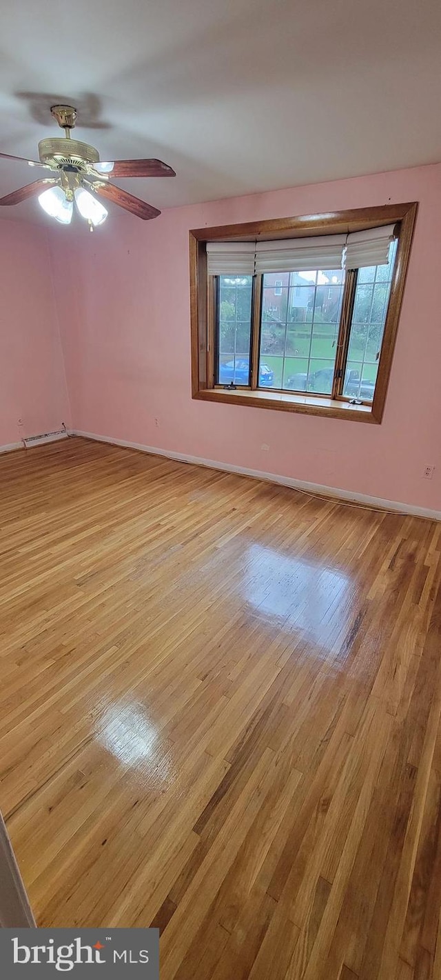 empty room featuring ceiling fan and light wood-type flooring