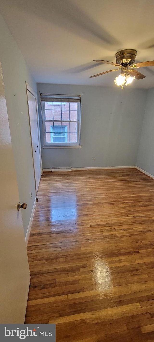 spare room with ceiling fan and hardwood / wood-style floors