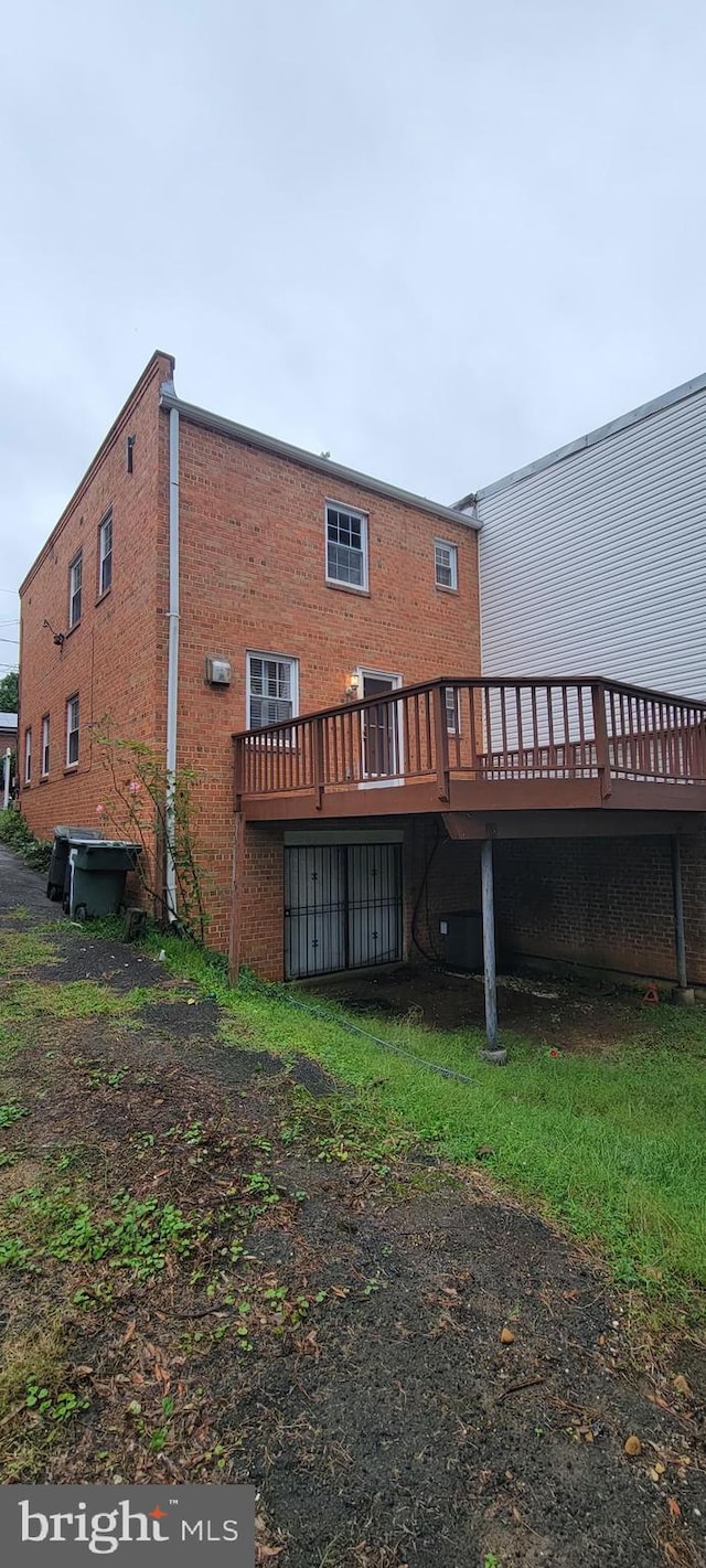 back of house featuring a wooden deck