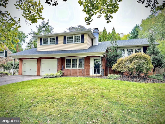 view of front of property with a front yard and a garage