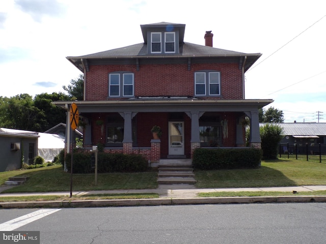 view of front of property featuring covered porch and a front yard