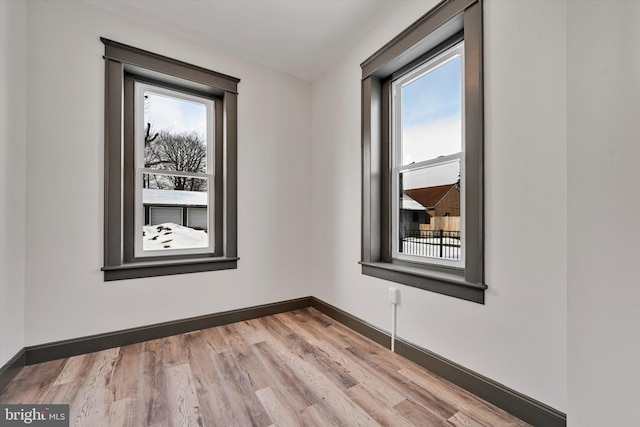 spare room with light hardwood / wood-style floors