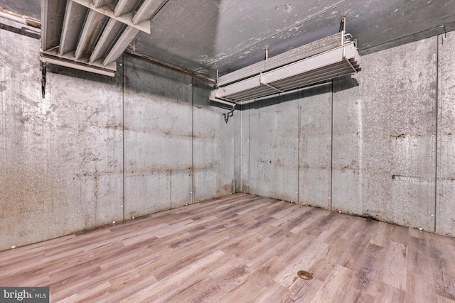 basement with hardwood / wood-style floors