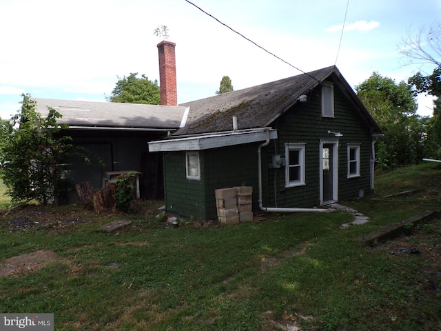 rear view of property with a yard