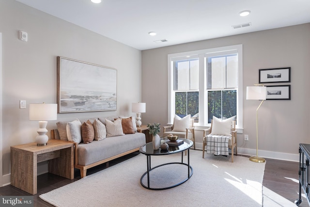 living room featuring baseboards, wood finished floors, visible vents, and recessed lighting