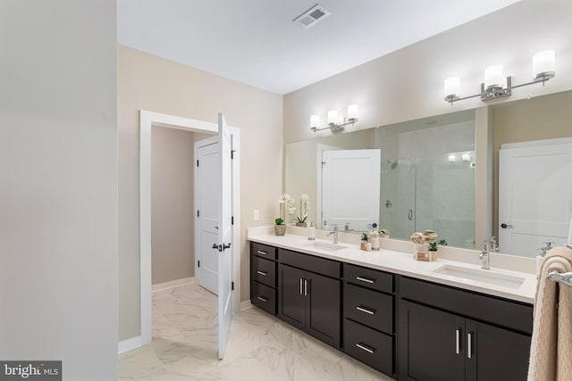 bathroom with marble finish floor, a sink, visible vents, and a stall shower