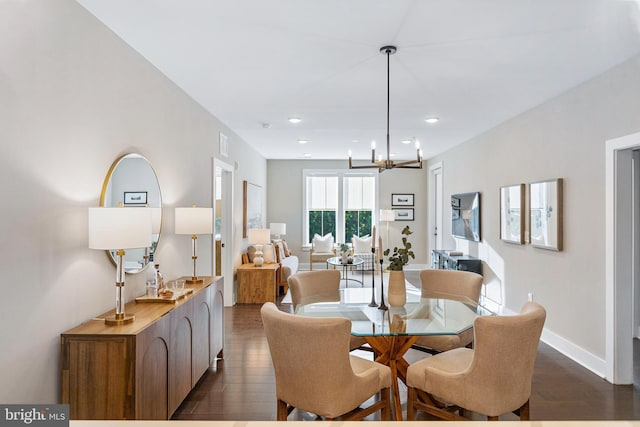 dining area with recessed lighting, visible vents, dark wood-type flooring, baseboards, and a notable chandelier