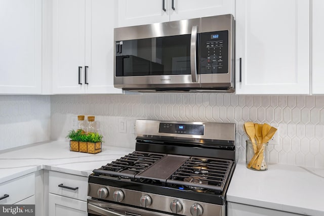 kitchen featuring appliances with stainless steel finishes and white cabinetry