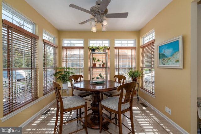 tiled dining area with ceiling fan