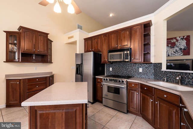 kitchen featuring lofted ceiling, stainless steel appliances, backsplash, sink, and light tile patterned floors