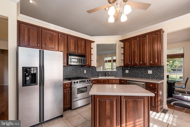 kitchen featuring ornamental molding, sink, a center island, and stainless steel appliances