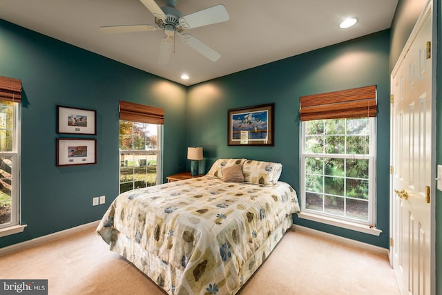 bedroom featuring light carpet and ceiling fan