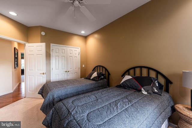 bedroom featuring wood-type flooring, a closet, and ceiling fan