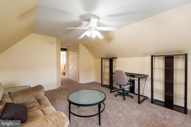 carpeted home office with lofted ceiling and ceiling fan