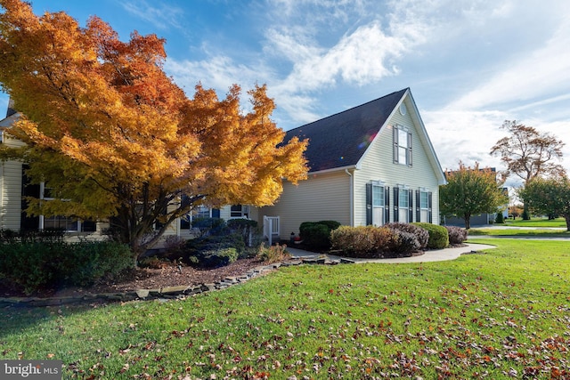 view of home's exterior with a yard