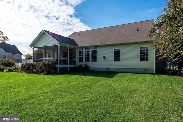 back of house with a yard and a sunroom