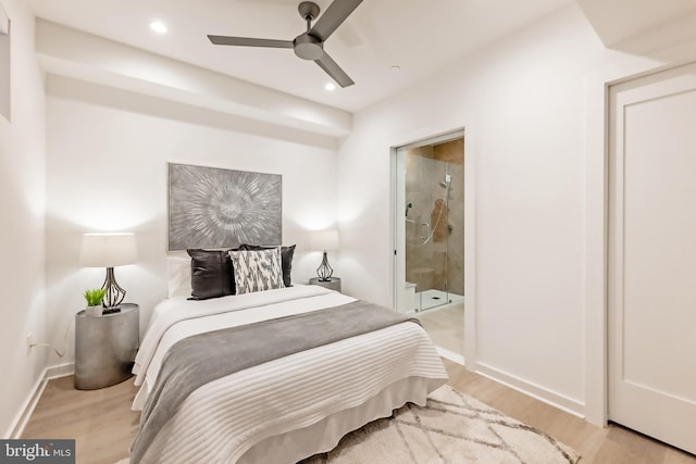 bedroom with ceiling fan, light wood-type flooring, and ensuite bathroom