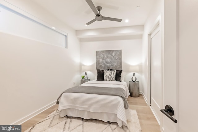 bedroom with light wood-type flooring and ceiling fan