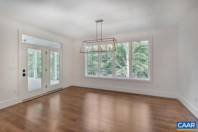 unfurnished dining area with ornamental molding, a wealth of natural light, a chandelier, and dark hardwood / wood-style floors