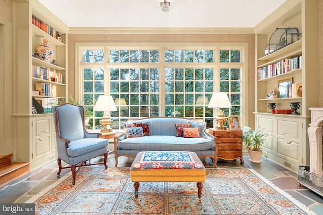 living area featuring crown molding and built in features