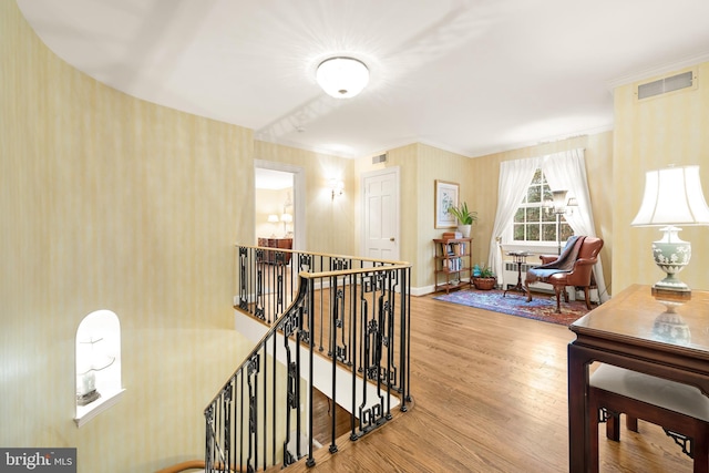 interior space with wood-type flooring and crown molding