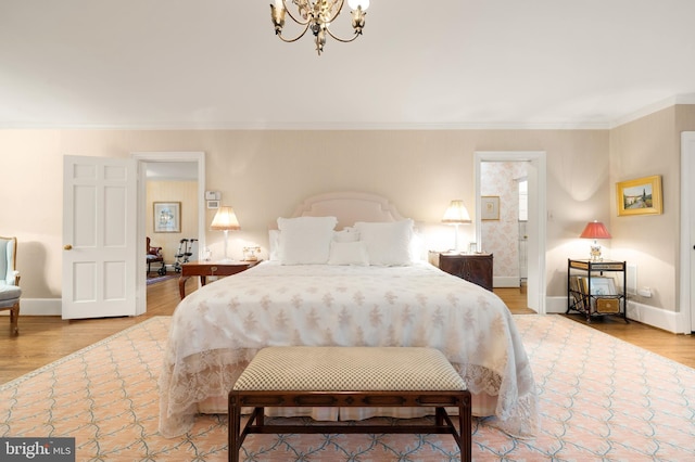 bedroom featuring crown molding, a notable chandelier, and hardwood / wood-style flooring