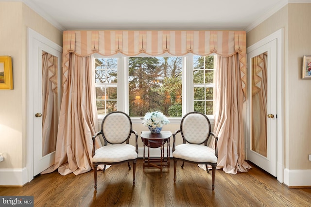 living area featuring crown molding and hardwood / wood-style floors