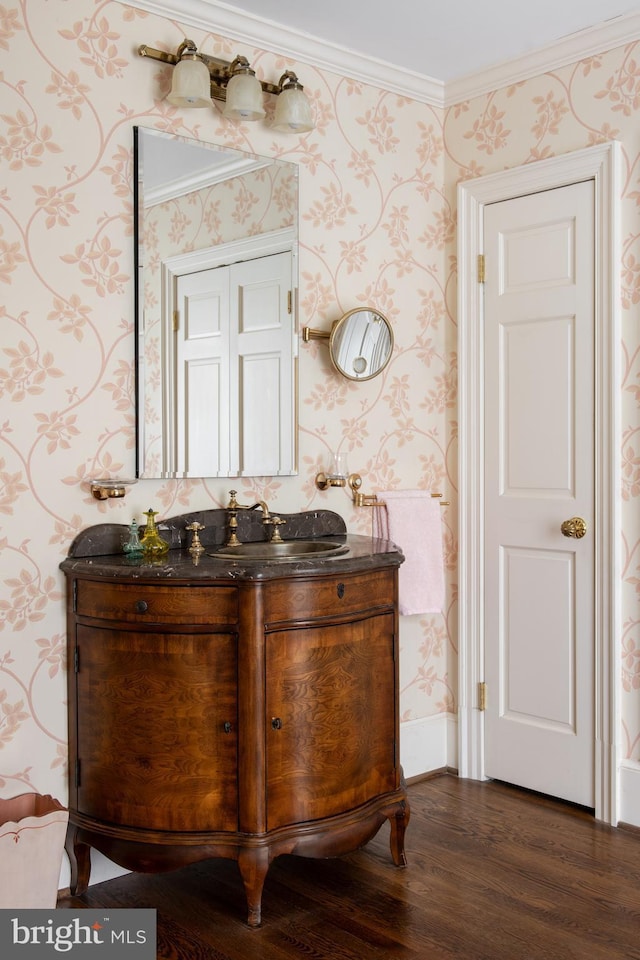 bathroom with vanity, wood-type flooring, and ornamental molding