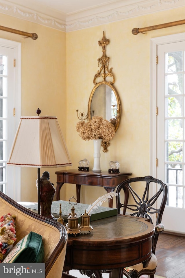 living area with ornamental molding and hardwood / wood-style floors