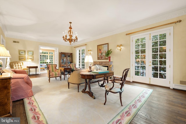 dining room with hardwood / wood-style floors, crown molding, a fireplace, and french doors