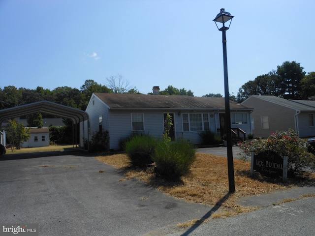 ranch-style home featuring a carport