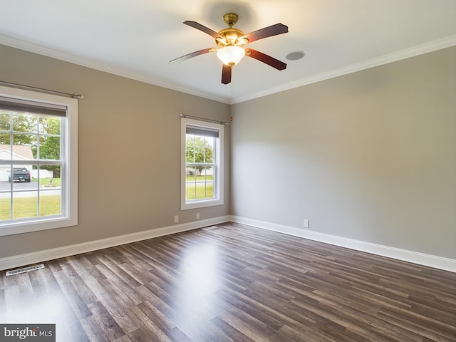 spare room featuring a healthy amount of sunlight, dark hardwood / wood-style floors, and ceiling fan