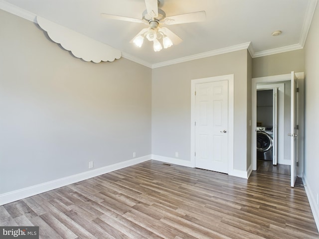 unfurnished bedroom featuring ornamental molding, wood-type flooring, washer / clothes dryer, and ceiling fan