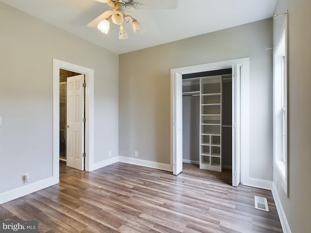 unfurnished bedroom with a closet, light hardwood / wood-style floors, and ceiling fan