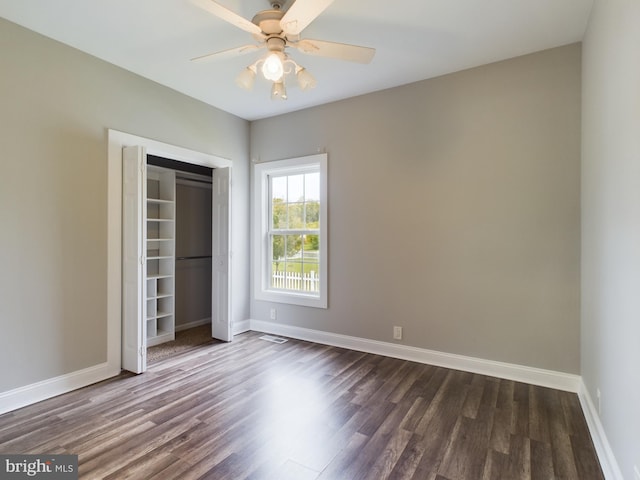 unfurnished bedroom featuring a closet, ceiling fan, and dark hardwood / wood-style floors