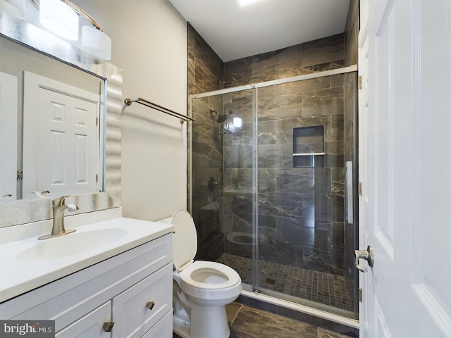 bathroom with vanity, toilet, and an enclosed shower