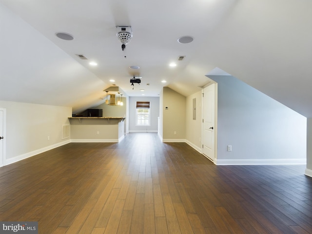 bonus room with vaulted ceiling and dark hardwood / wood-style flooring