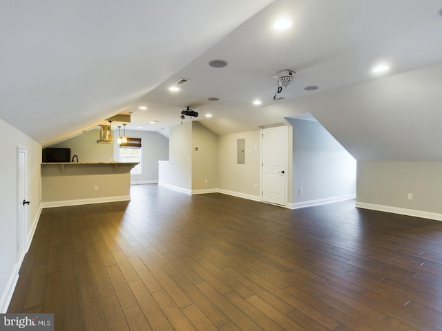 bonus room with sink, lofted ceiling, dark wood-type flooring, and electric panel