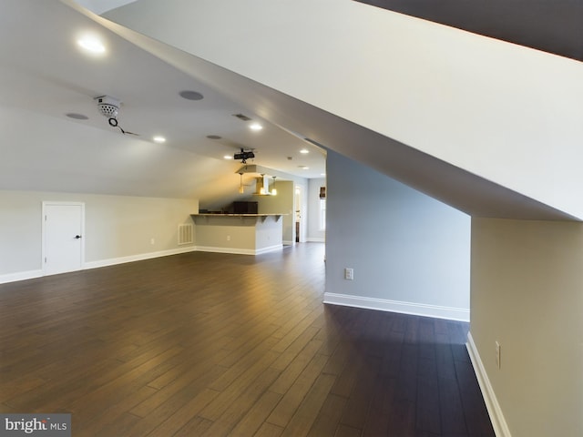 bonus room featuring lofted ceiling and dark hardwood / wood-style floors