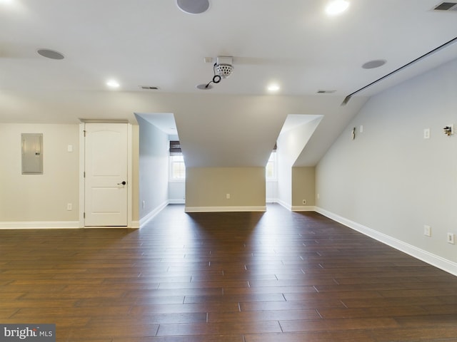 additional living space featuring electric panel and dark wood-type flooring