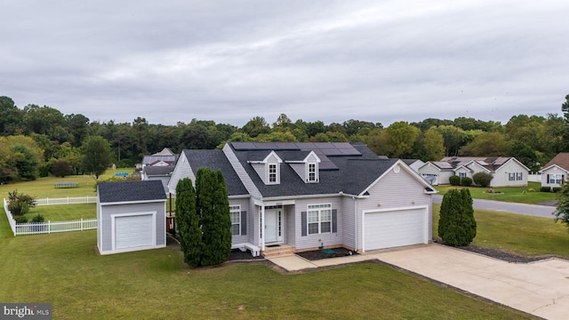 new england style home with a garage, solar panels, and a front lawn