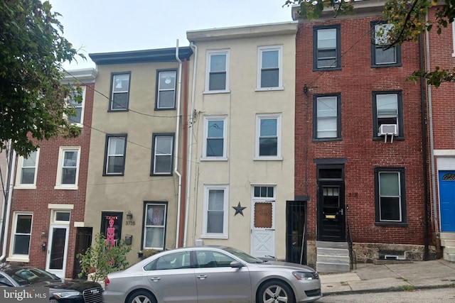 townhome / multi-family property with stucco siding and entry steps