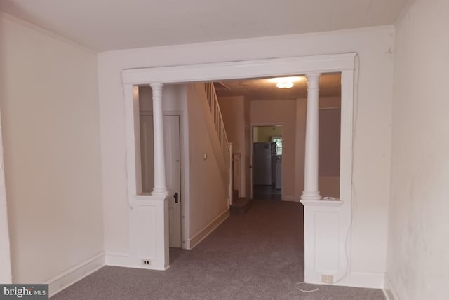 corridor featuring carpet floors, ornamental molding, and baseboards