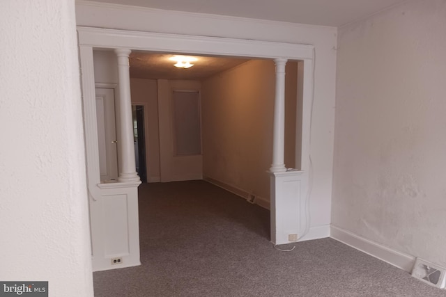 hallway with carpet floors, baseboards, and visible vents